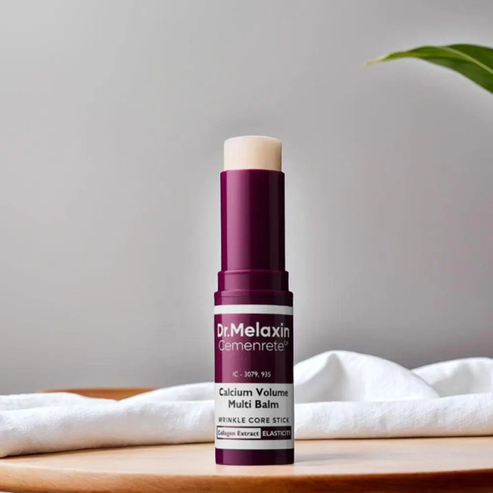 Dr Melaxin calcium multi balm stick in purple and white packaging on wooden surface with white cloth background